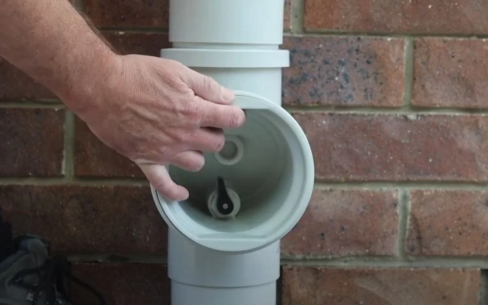Plumber inserting HD sewer diagnostic camera into cleanout access point