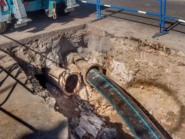 Underground trench excavation with sewer pipe insertion and targeted spot repair in Salt Lake City